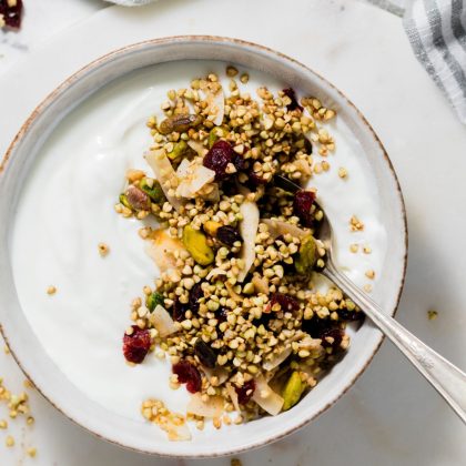 buckwheat granola with yogurt in white bowl.