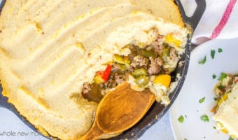 paleo shepherd's pie in cast iron skillet with wooden spoon