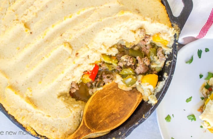 paleo shepherd's pie in cast iron skillet with wooden spoon
