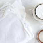 homemade baby laundry detergent with baby onesies