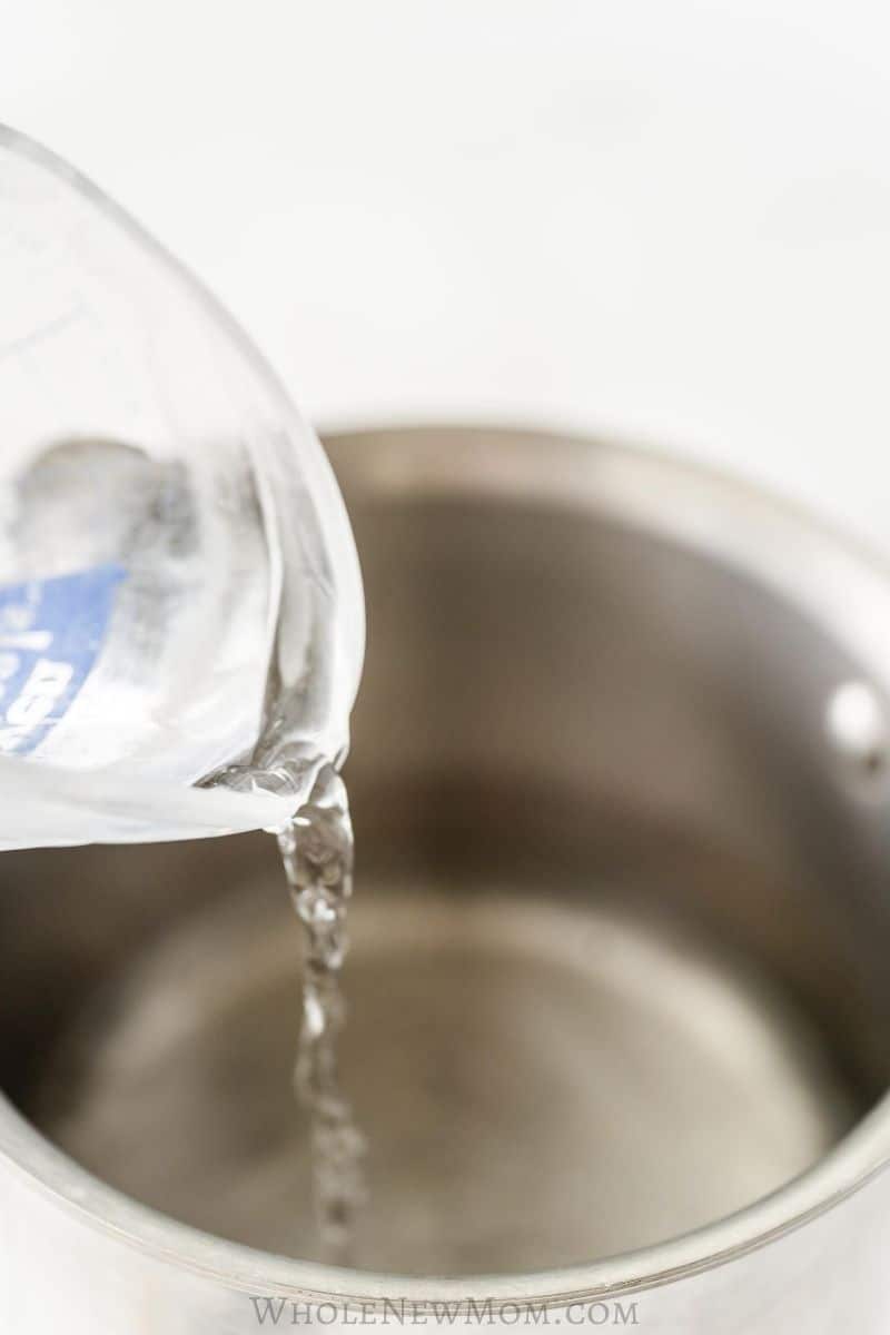 pouring water into pot to make homemade keto simple syrup