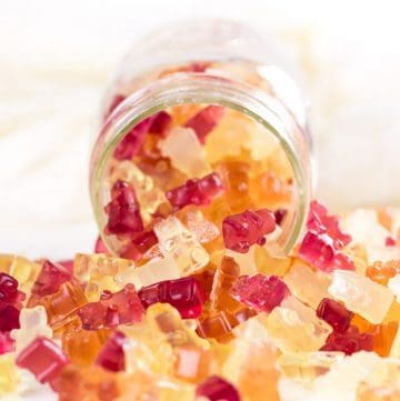 sugar-free homemade gummies spilling out of a mason jar.