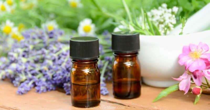 small essential oil bottles with flowers in the background