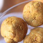 soft pumpkin cookies on a clear plate.