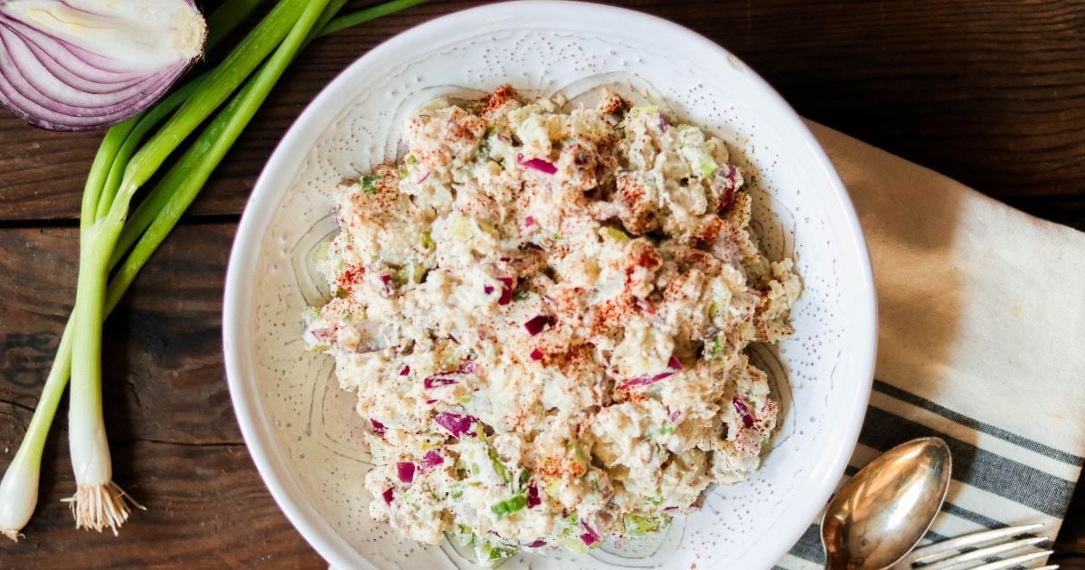 cauliflower potato salad in white bowl.