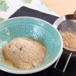 powdered sugar in a bowl and in a sifter.