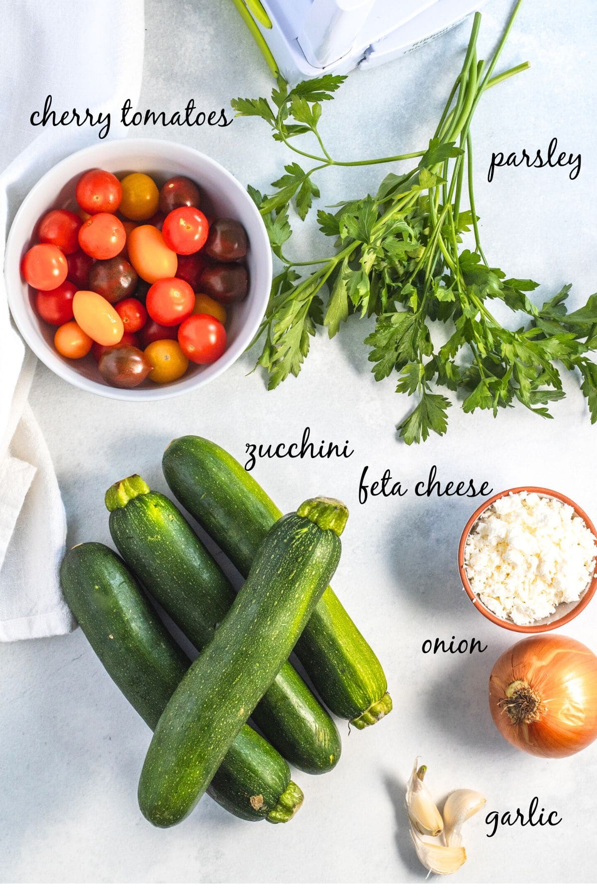 ingredients for zucchini noodles and cherry tomatoes dish.