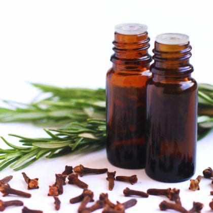 essential oil bottles with clove and rosemary.