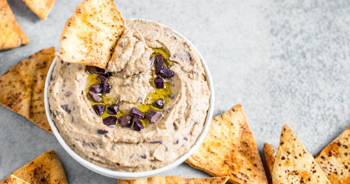 olive hummus with pita chips.