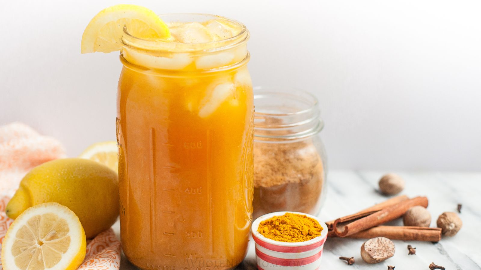 adrenal cocktail powder with homemade adrenal cocktail in large mason jar.