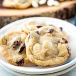 gluten-free white chocolate cranberry cookies on white plates.