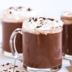 protein hot chocolate in glass mug with whipped cream.
