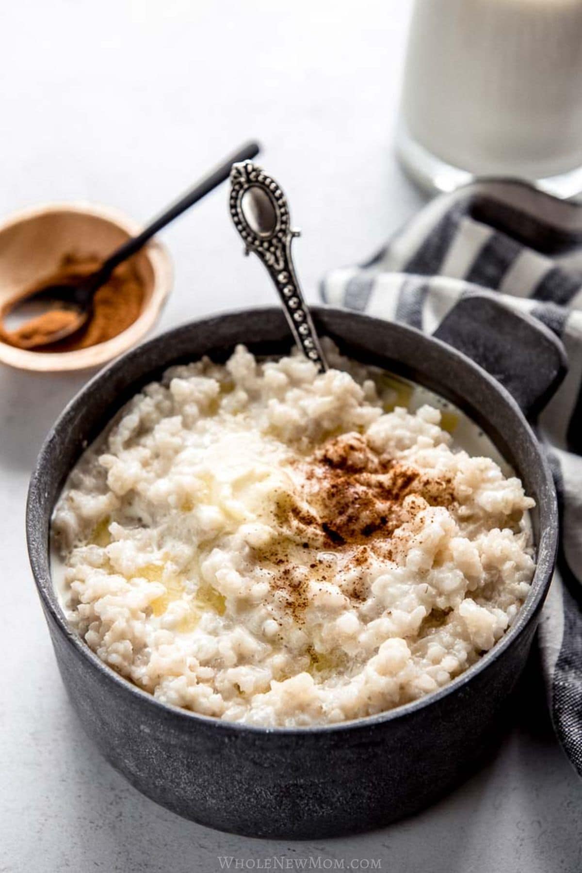 homemade cream of rice in stoneware bowl with cinnamon and butter on top.