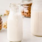 homemade almond milk in small glass jar.