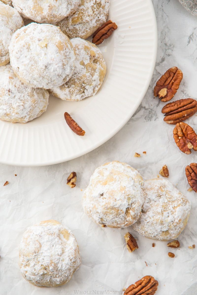 keto snowball cookies on white plate and on marble table.