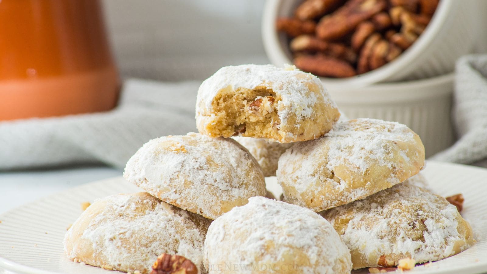 keto snowball cookies on white plate.
