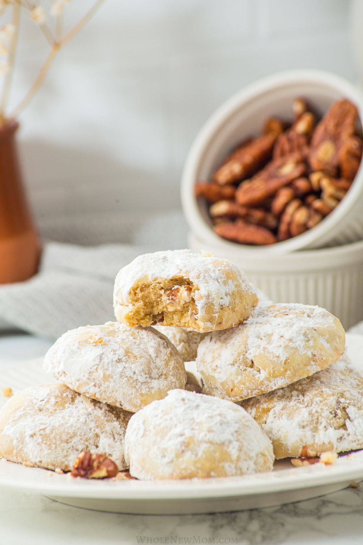 keto snowball cookies on white plate.