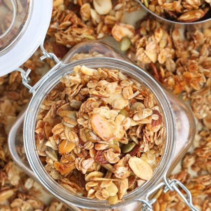 sugar-free granola in jar on top of baking pan with more granola.