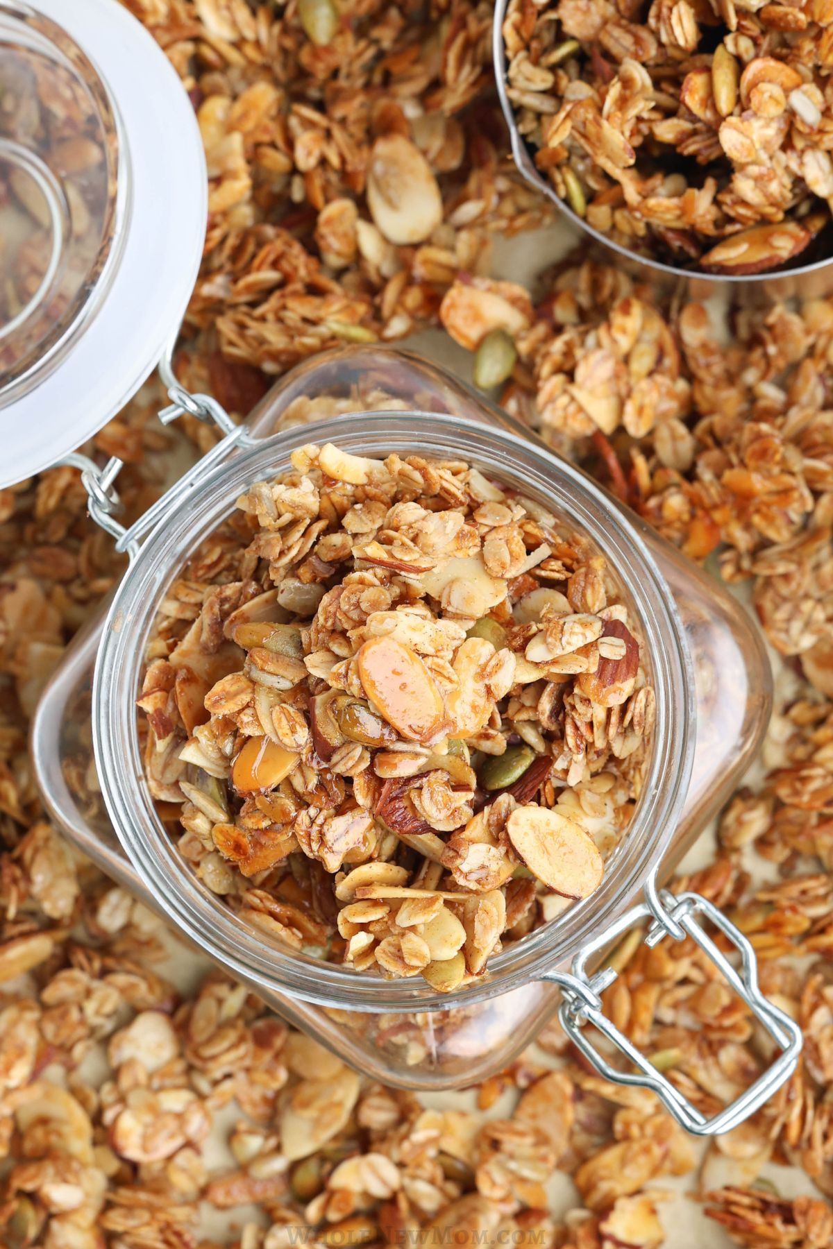 sugar-free granola in jar on baking sheet.