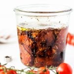 homemade sun-dried tomatoes with olive oil and herbs in weck jar.