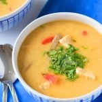 thai coconut chicken soup (tom kha gai) in white and blue bowl.