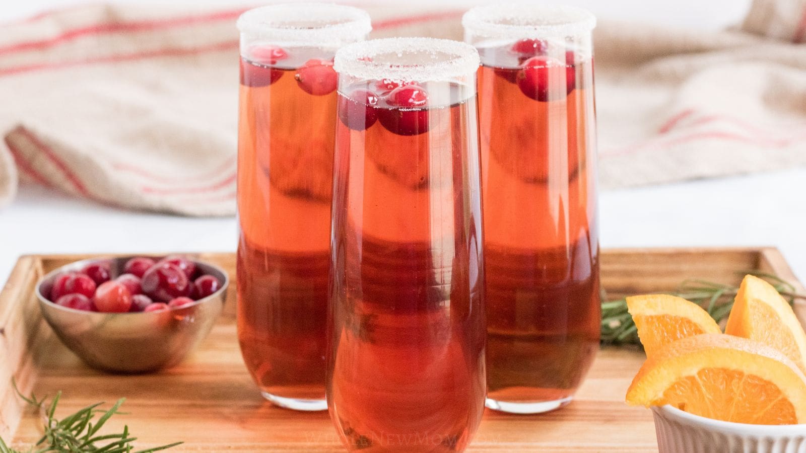 cranberry mocktails on wood tray.