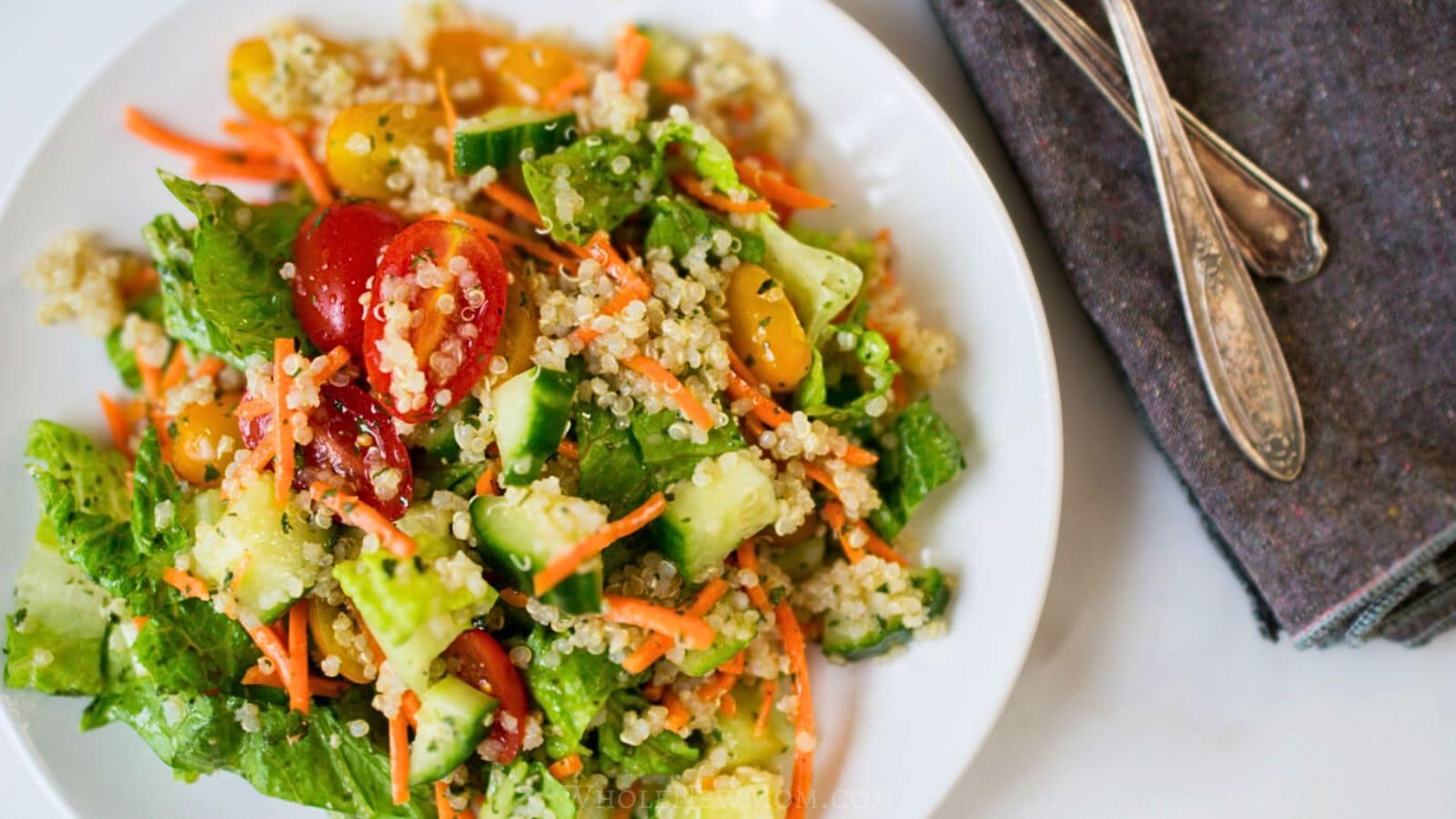 garden quinoa salad on white plate.