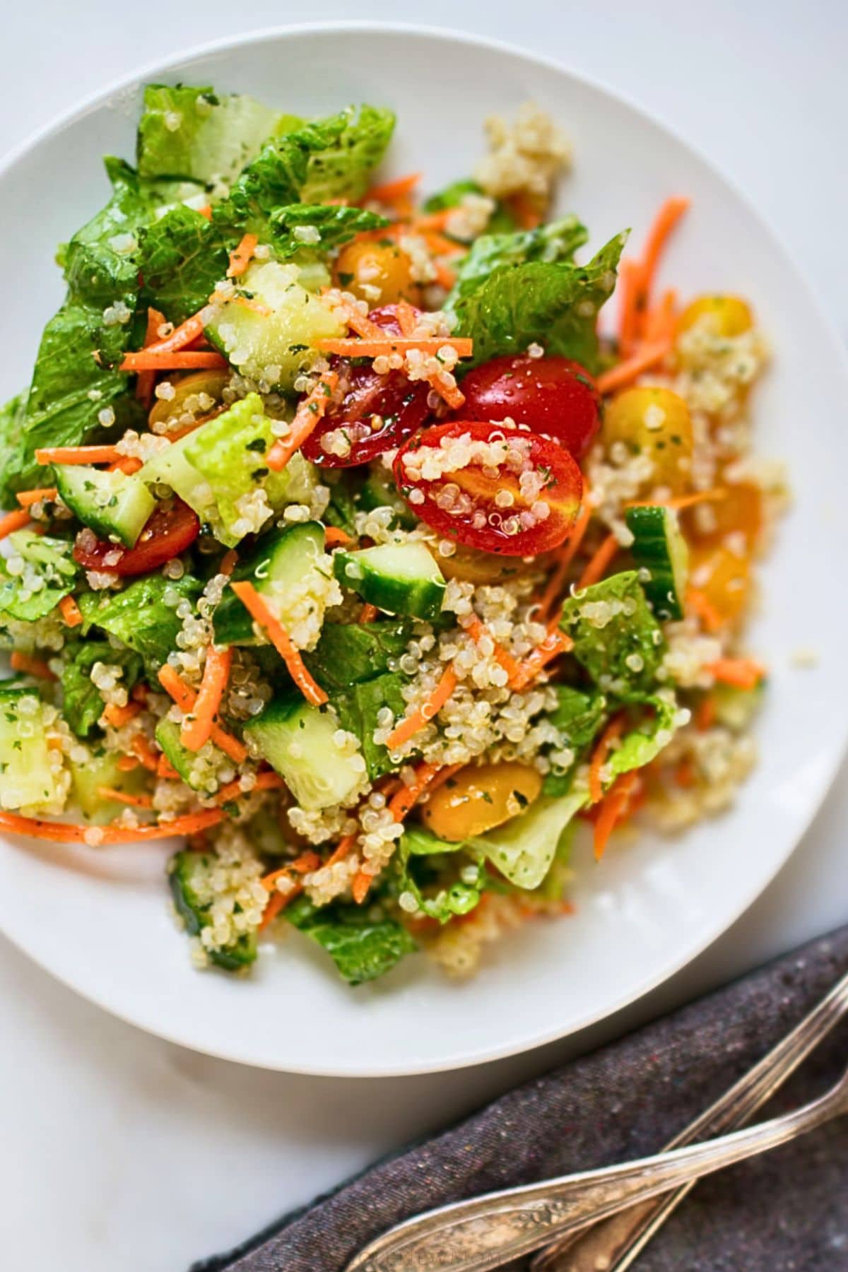 garden quinoa salad on white plate.