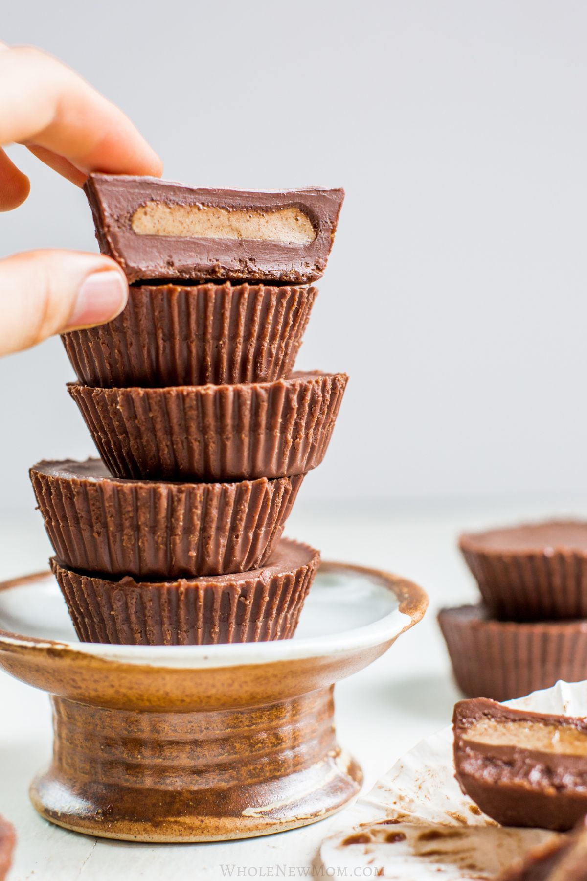 stack of sugar-free almond butter cups on small stand.