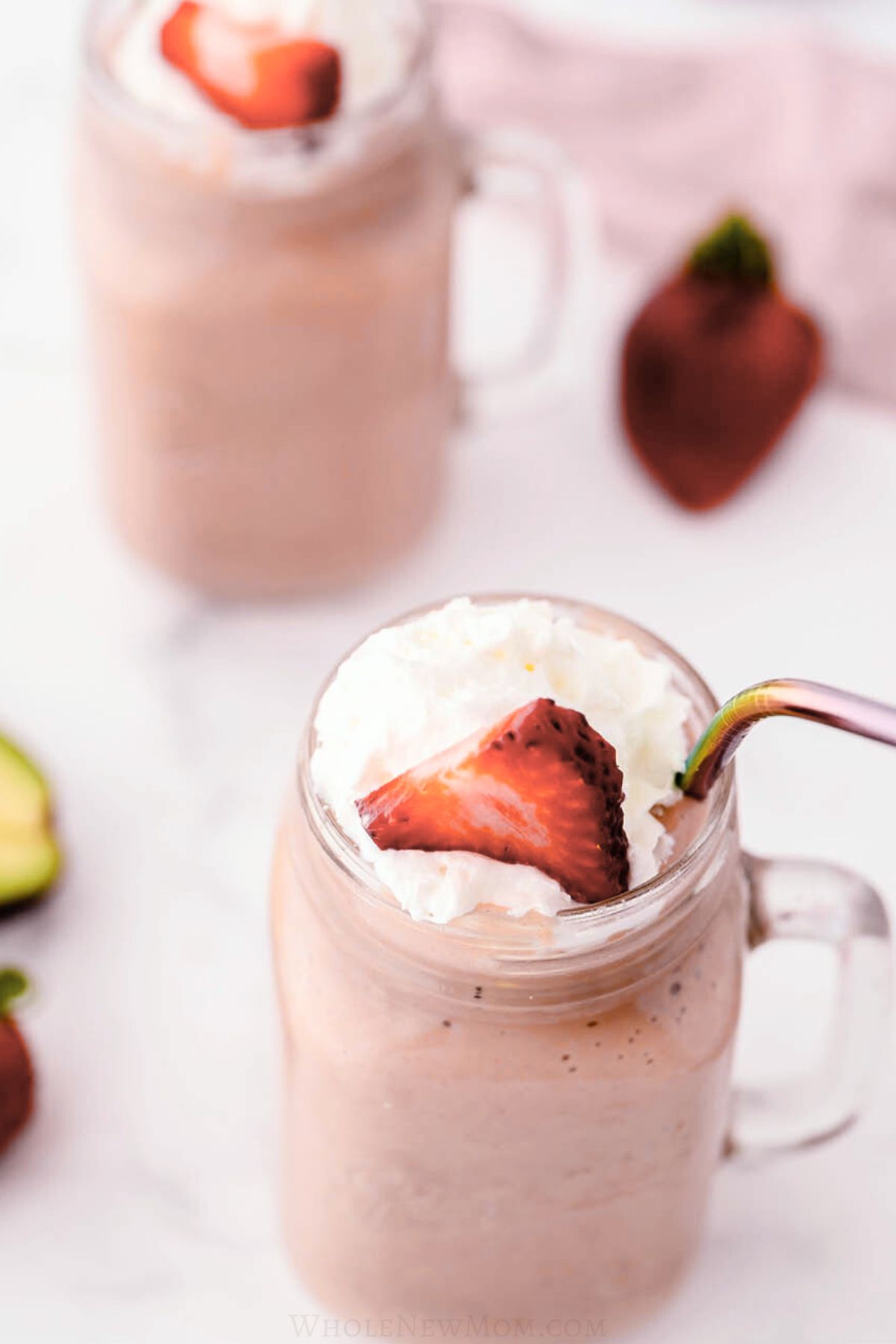 strawberry avocado smoothies in mason jar mugs.
