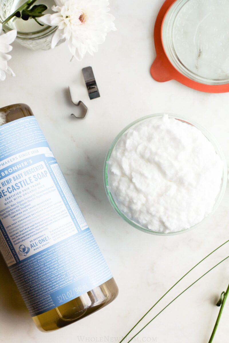 baking soda cleaning paste with castile soap on marble tabletop.