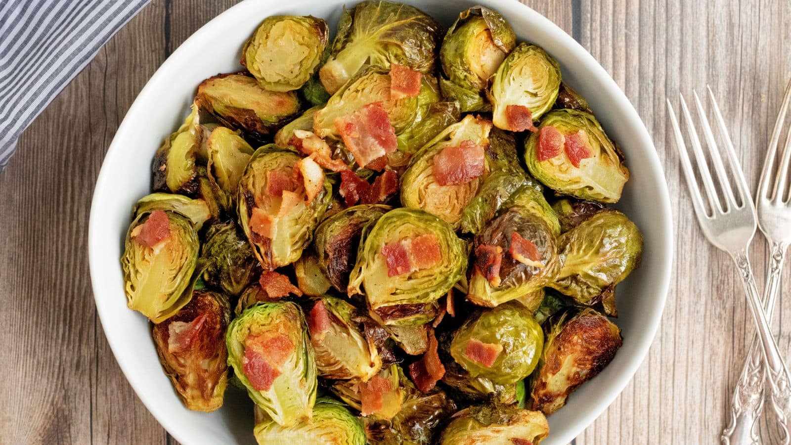 crispy roasted brussels sprouts with bacon in a bowl.