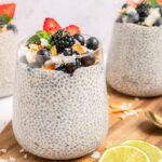 coconut chia pudding with berries and coconut flakes in a glass jar