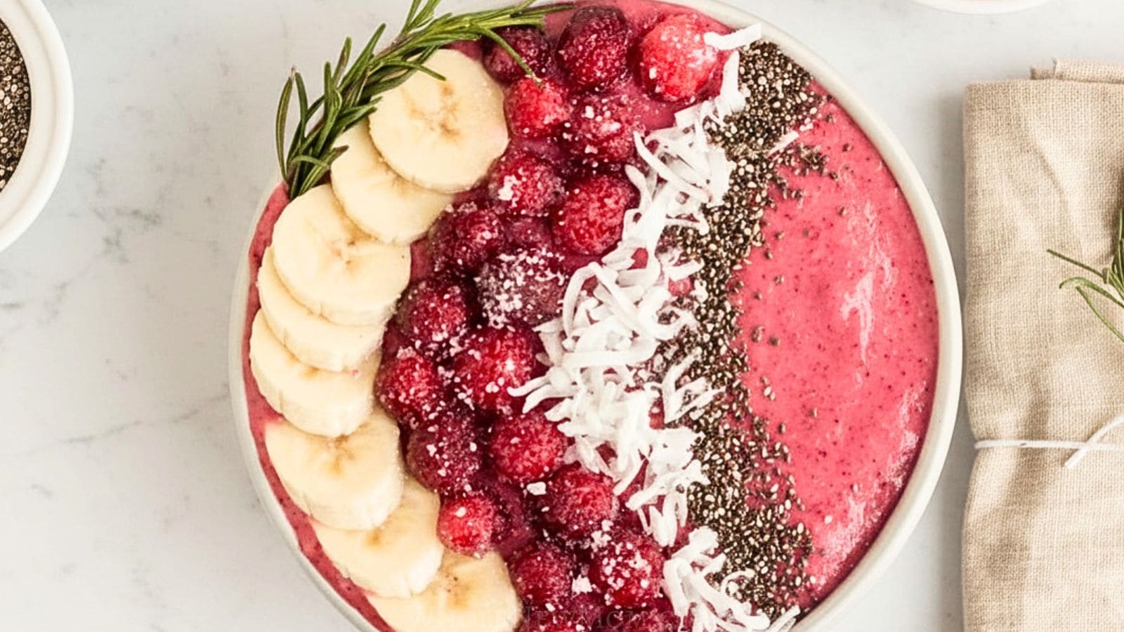 cranberry smoothie bowl with bananas, cranberries and coconut shreds.