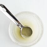 gelatin egg in small glass bowl with measuring spoon.