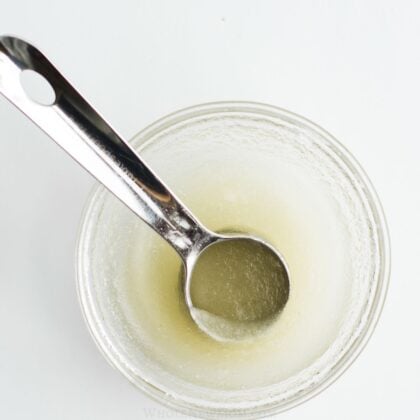 gelatin egg in small glass bowl with measuring spoon.