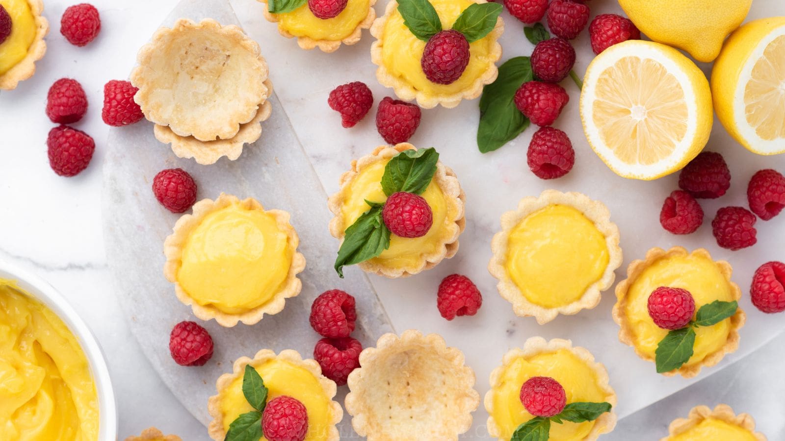 mini lemon tarts with raspberries and mint.