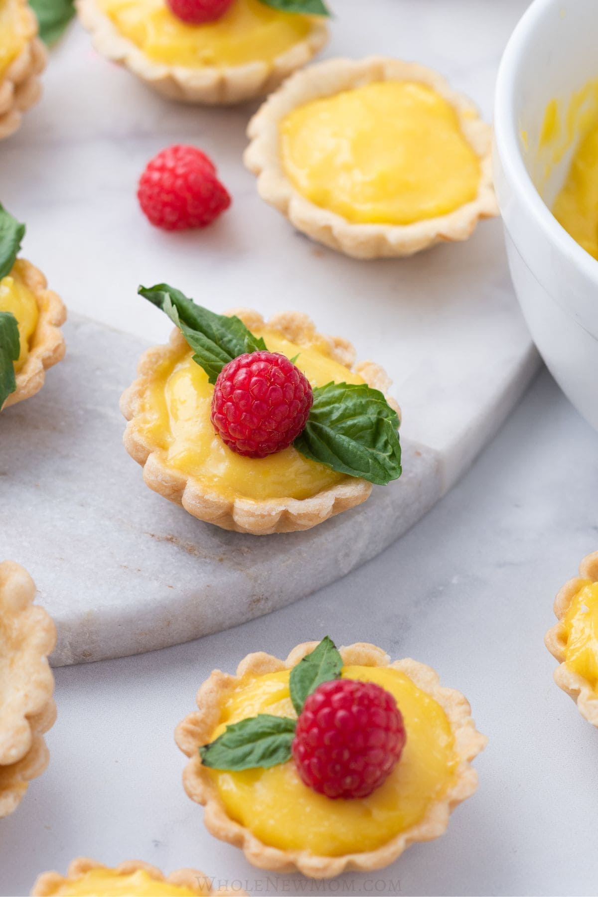 gluten free lemon tartlets with fresh raspberries.