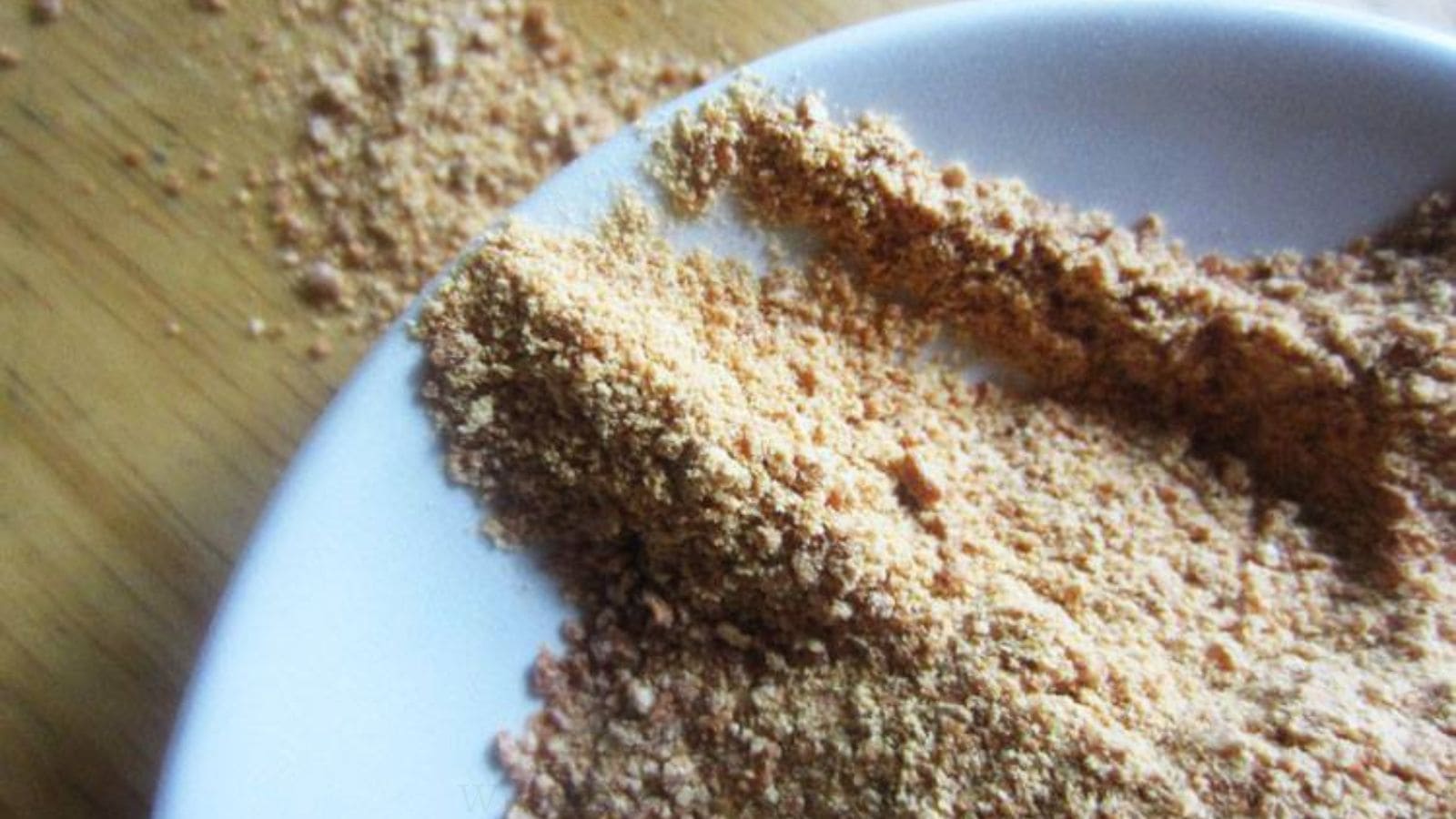 granulated garlic or garlic powder on white plate.