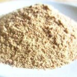 homemade granulated garlic on white plate.