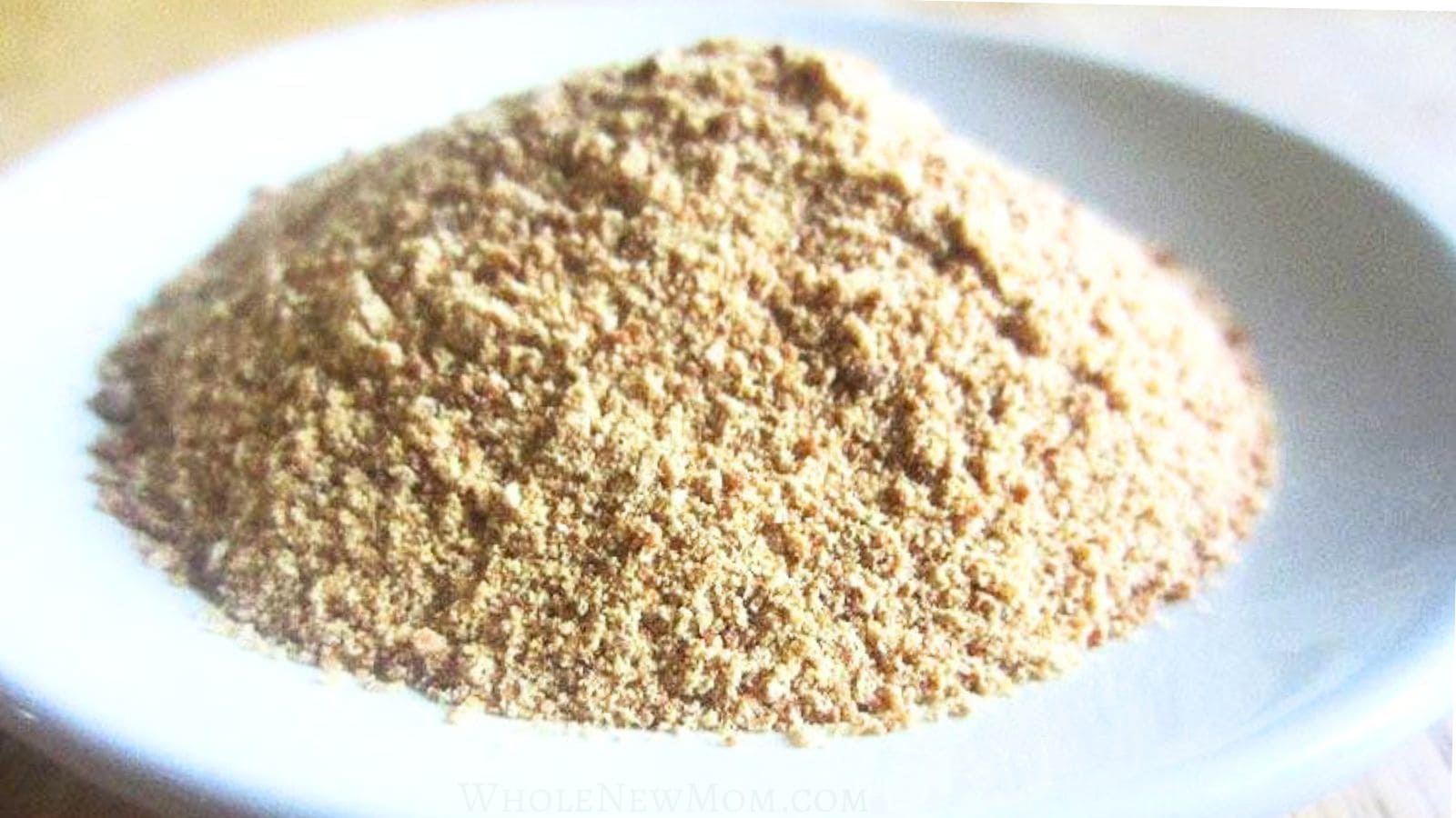 homemade granulated garlic or garlic powder on white plate.