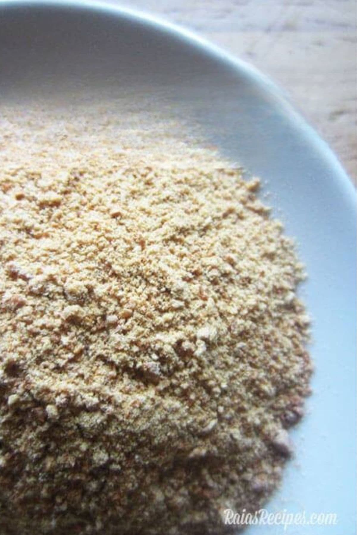 homemade granulated garlic or garlic powder in light blue bowl.