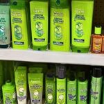 drugstore shampoos on store shelf showing common hair care products with potentially harmful ingredients