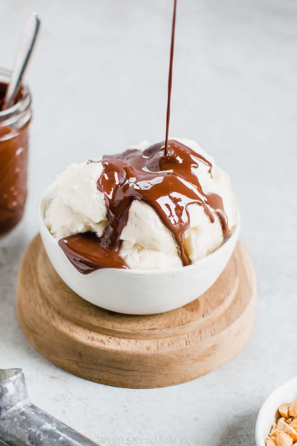 sugar free chocolate magic shell being drizzled onto vanilla ice cream.