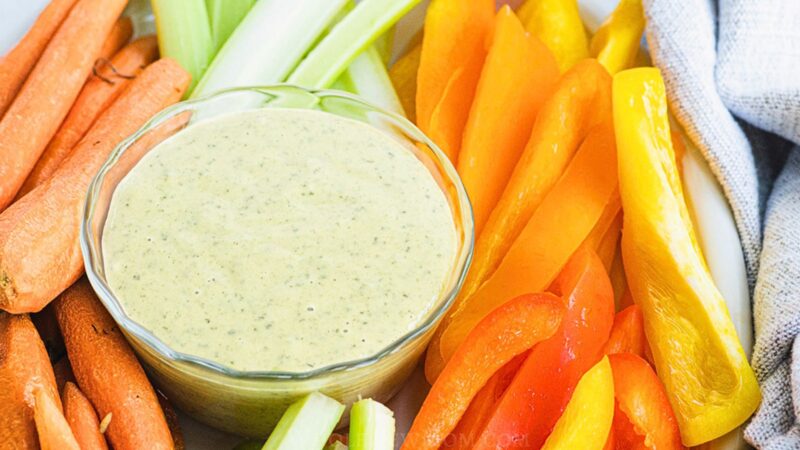 vegan ranch dressing in glass bowl on veggie platter.