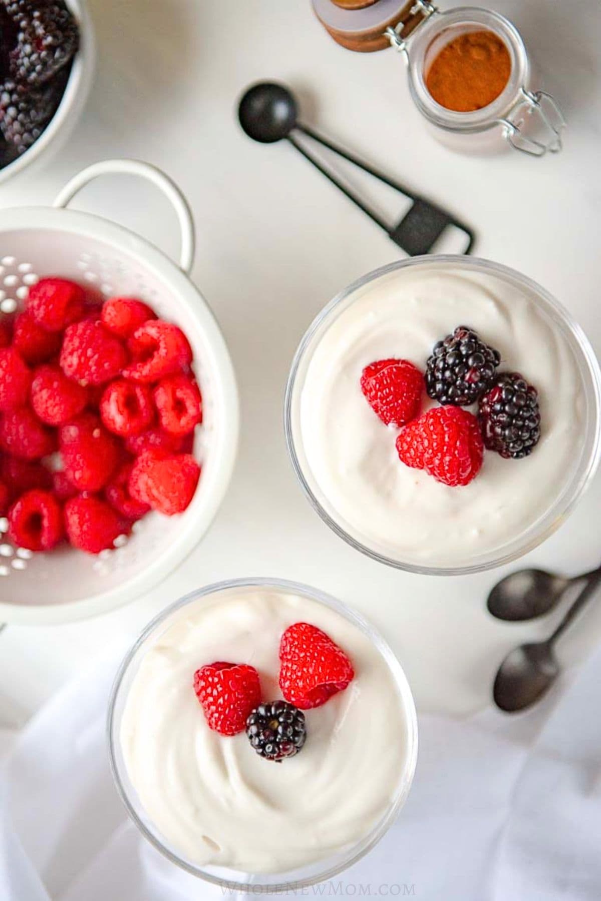 keto coconut pudding in dessert cups with berries.