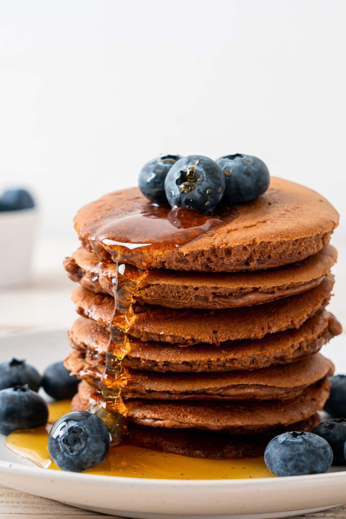 teff pancakes with blueberries and syrup.