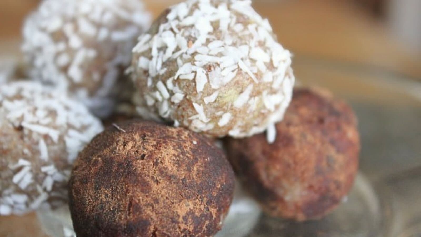 almond butter balls on glass plate.