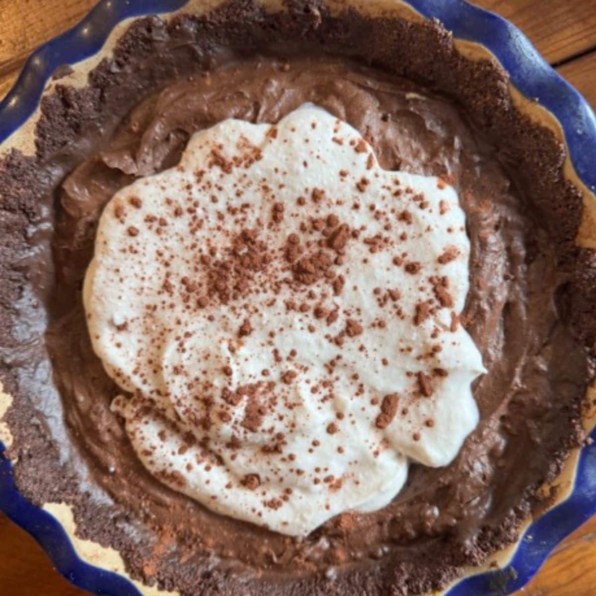 chocolate avocado pie in blue ceramic pie plate.