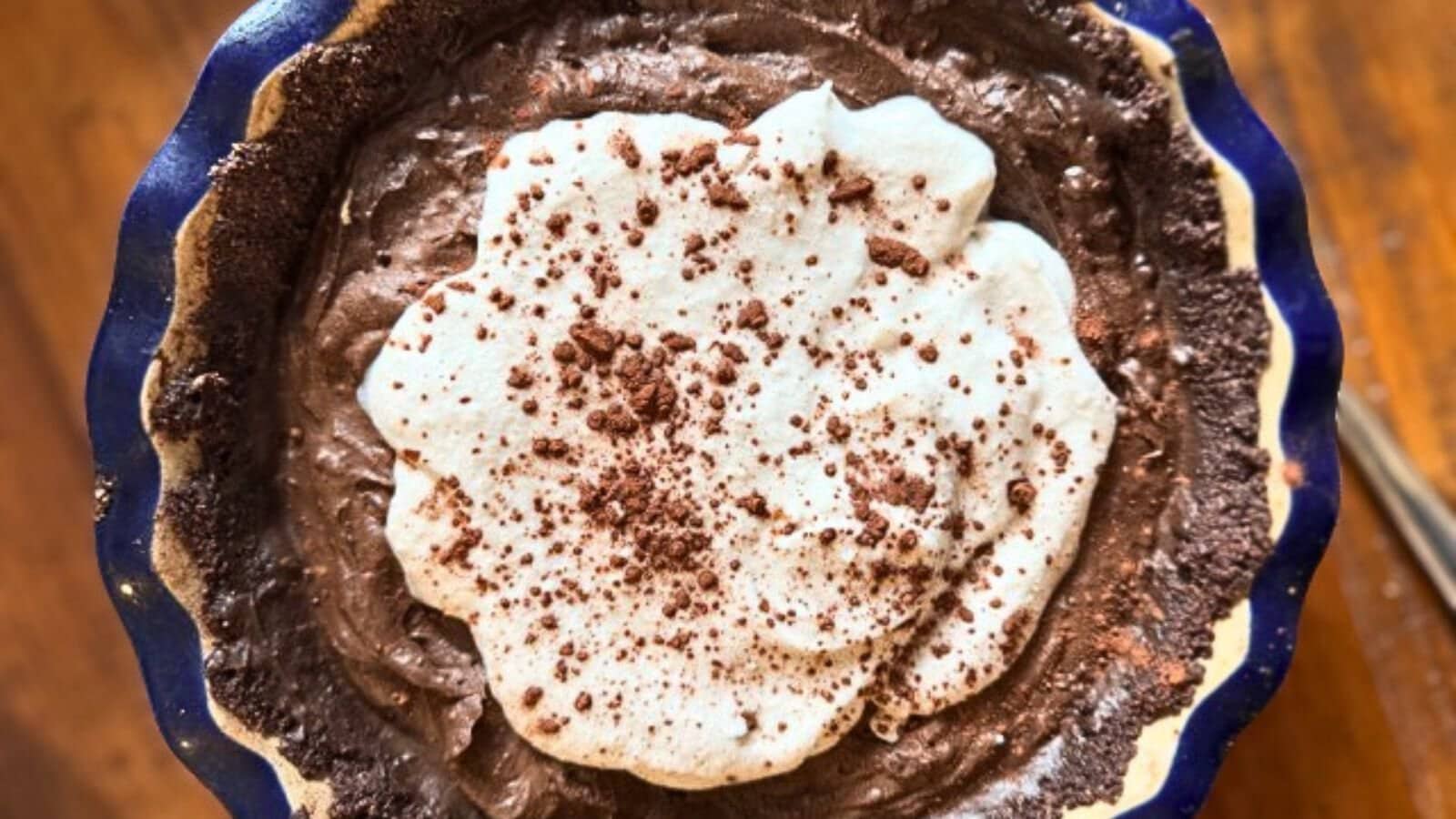 chocolate avocado pie in blue ceramic pie plate.